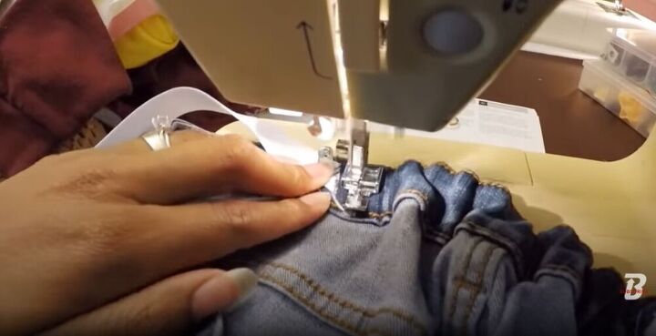 15 amazing ways you can easily alter and upcycle jeans, Sewing the elastic into the jeans waistband