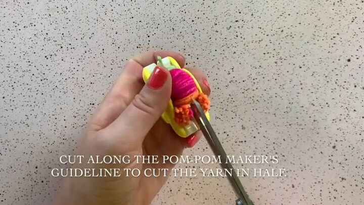 create an adorable pom pom keychain with this easy tutorial, Cut your DIY pom pom
