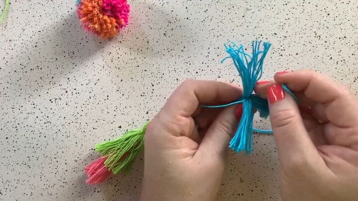 create an adorable pom pom keychain with this easy tutorial, Thread the tassels