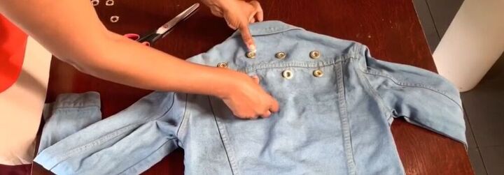 modernize your jean jacket with this awesome diy, Place the grommets