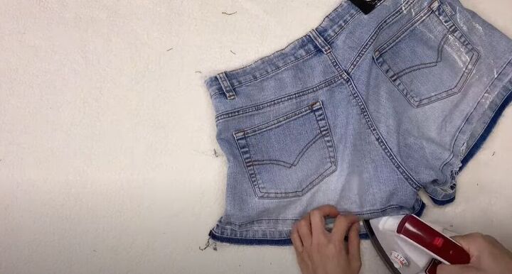 how to take in and style up a pair of jean shorts, Press the fabric