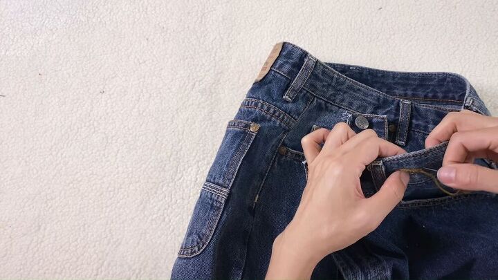 turn some frumpy jean shorts into a hip distressed asymmetrical skirt, Jean skirt refashion