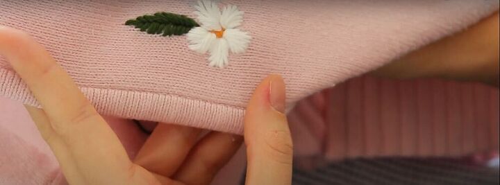 how to upcycle an old zip up into an adorable embroidered sweater, Embroidered flower with leaf