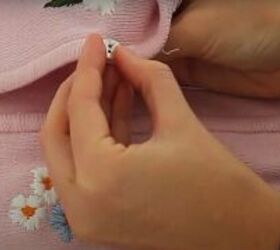 how to upcycle an old zip up into an adorable embroidered sweater, Sew on the buttons