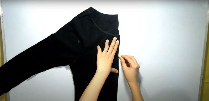 how to make 2 different diy crop tops out of 1 old shirt, Folding the shirt in half to make the pattern