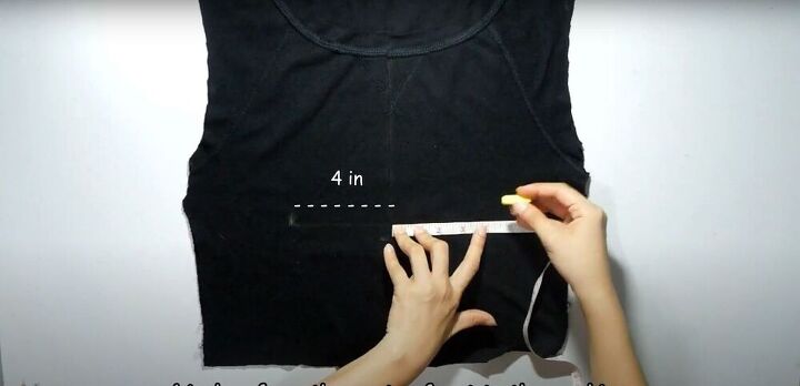 how to make 2 different diy crop tops out of 1 old shirt, Measuring where the twist will go