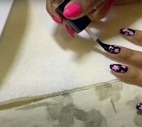 try this easy cherry blossom nail art to create blissful sakura nails, Applying top coat to sakura nails