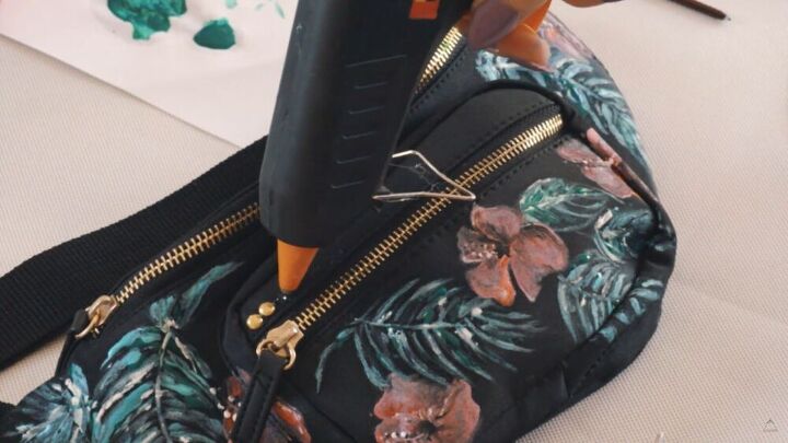 make a unique diy fanny pack with this fun bag painting tutorial, Gluing studs onto the bag