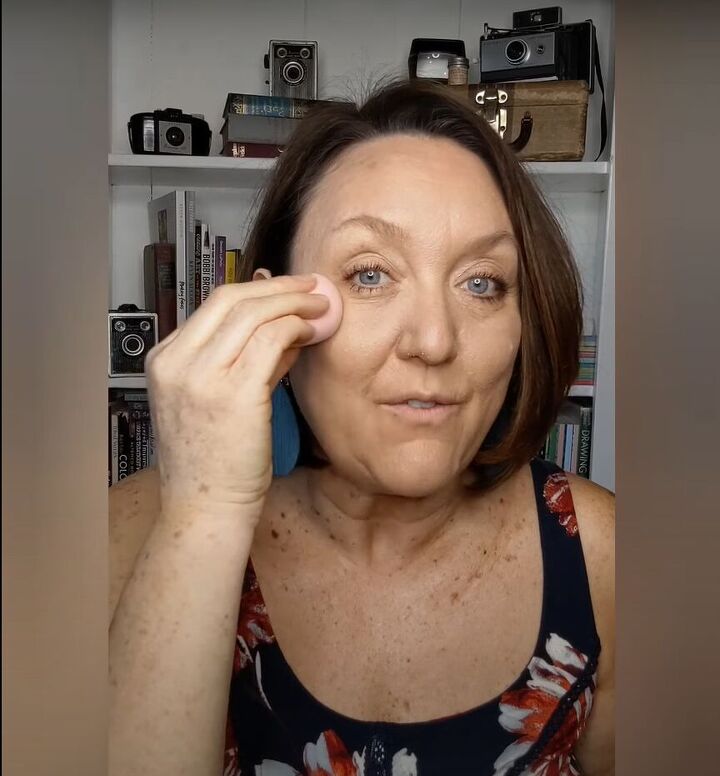 how to cover up sun spots with makeup tutorial for mature skin, Pressing a damp sponge onto my face