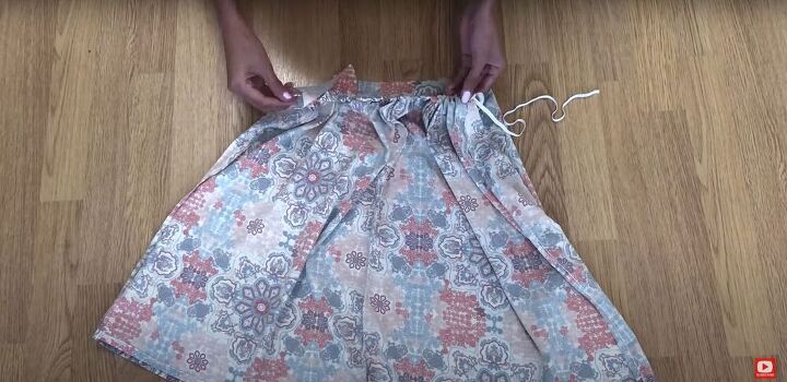 this pretty diy backless dress was made from an old maxi skirt, Threading the elastic through the waistband