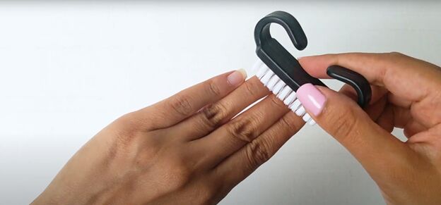 easy at home manicure how to cure gel nail polish with an led light, Using a nail brush to remove any debris