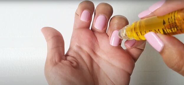 easy at home manicure how to cure gel nail polish with an led light, Using cuticle oil on nails
