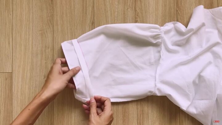 make this cute puff sleeve crop top out of an old men s shirt, Inserting the fabric onto the sleeve