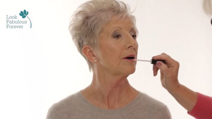 enhancing lip eye makeup for women over 60, Applying a little lip gloss for shine