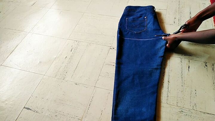 how to easily make a dungaree dress from old jeans, Cutting the jeans at the back crotch