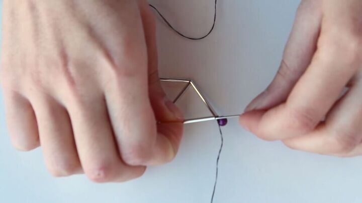 this diy geometric necklace is cool simple so easy to make, Threading the needle through the tube bead