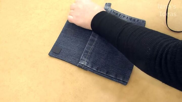got an old pair of jeans turn them into a cute diy denim clutch, Gluing velcro tape onto the DIY denim clutch