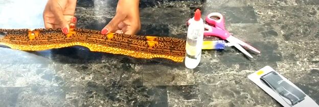 how to make an african fabric rope necklace quick simple tutorial, Rolling the fabric across the glued rope