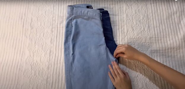 how to make low waisted jeans high waisted in 3 easy steps, Folding the jeans on top of each other