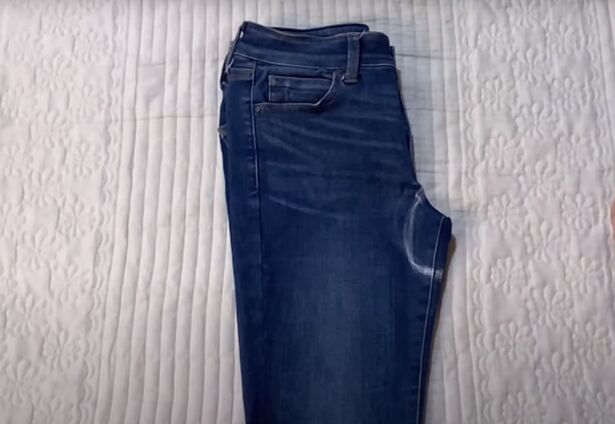 how to make low waisted jeans high waisted in 3 easy steps, Drawing a curve on the crotch of the jeans