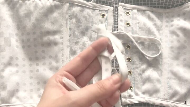 7 simple steps to sewing a corset top with boning eyelets, Adding ribbon to the corset eyelets