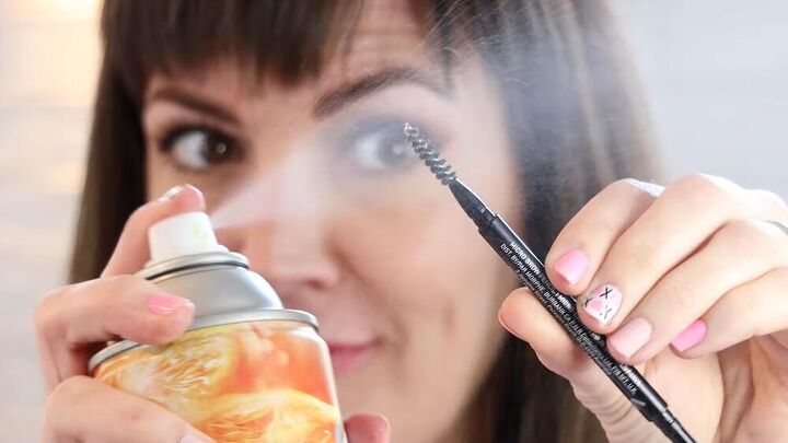 6 easy diy makeup beauty hacks that will save you money time, Spraying hairspray onto a spoolie brush