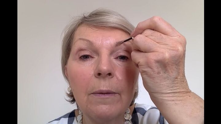 how to easily perfectly apply eye makeup for mature women, Applying eyebrow paint to fill in brows