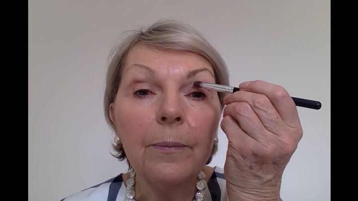 how to easily perfectly apply eye makeup for mature women, Applying a lighter eyeshadow to the inner eye