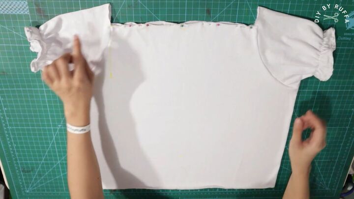 how to easily make a cute diy peasant top from a t shirt, Attaching elastic to the DIY peasant top