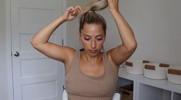 4 gym hairstyles for long hair that are cute easy to do stay secure, Tying hair into a high ponytail