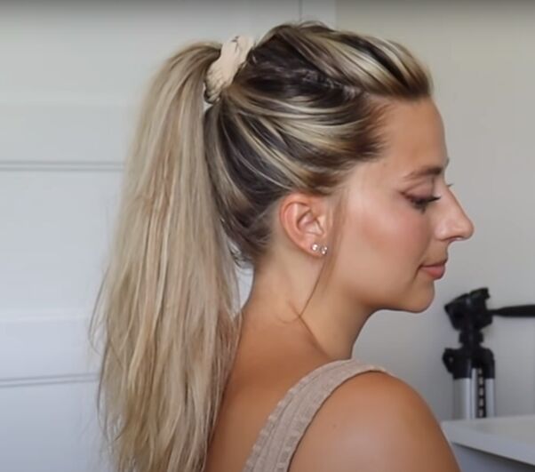 A woman with long hair in a high top knot at the gym.