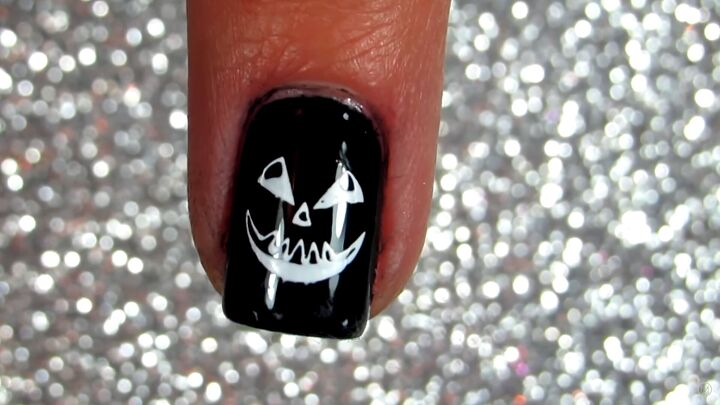 how to use halloween nail stamping plates for fast easy nail designs, Adding a clear top coat onto the nail design