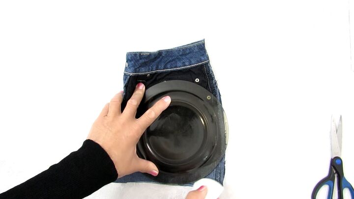 how to make a cute drawstring bag from old jeans step by step, Using a small plate to round the edges