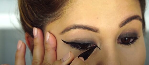 easiest halloween look ever here s how to do perfect cat girl makeup, Using eyeliner to create cat eyes