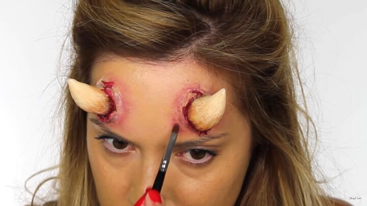 how to do sexy devil makeup for halloween complete with horns, Applying fake blood to the base of the horns