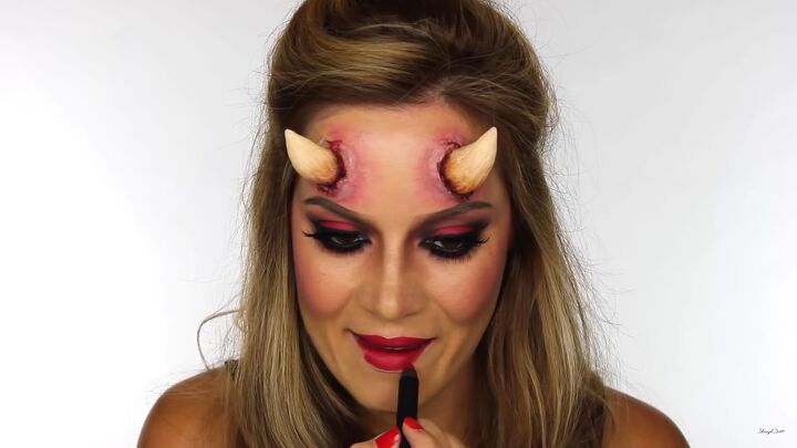 how to do sexy devil makeup for halloween complete with horns, Lining lips in a dark color