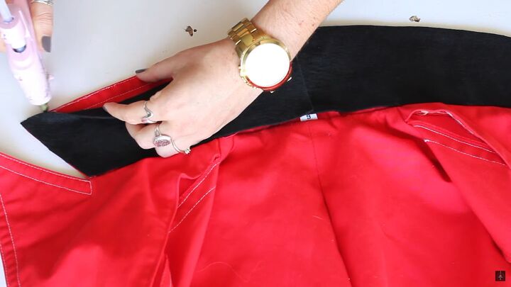 how to easily make a diy ringleader costume for halloween, Hot gluing the black felt onto the jacket
