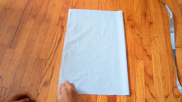 how to sew an alice in wonderland blue dress for cosplay or halloween, Folding the fabric in half to make the bodice