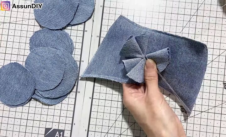 cute diy slippers tutorial how to make slippers from old jeans, Sewing the flower onto the DIY slippers