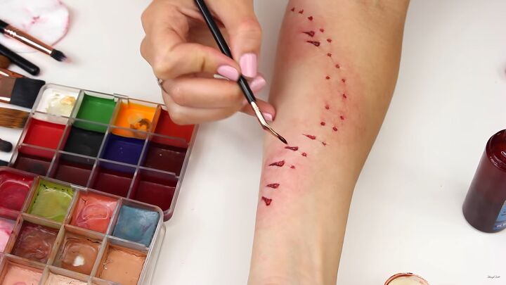 how to do realistic diy shark bite makeup for a fun halloween costume, Adding shine to the lacerations