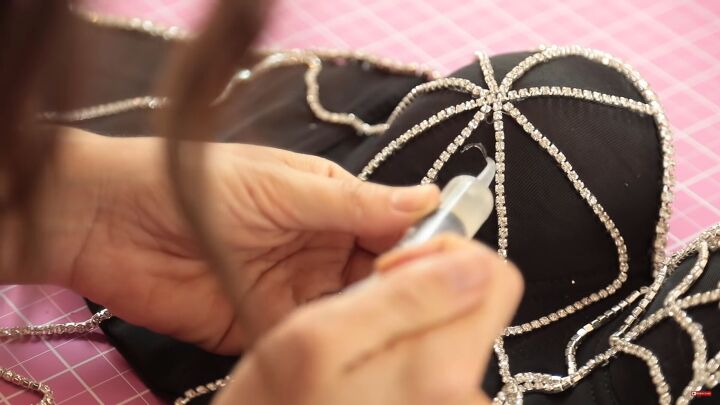 how to make a sexy sparkly diy spider web costume for halloween, Gluing the spiderweb trim on the bust of the corset