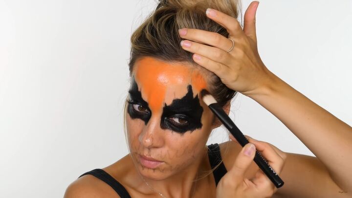 how to do creepy pumpkin makeup for halloween using cheap face paint, Applying orange face paint