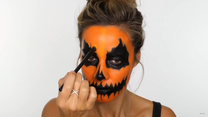 how to do creepy pumpkin makeup for halloween using cheap face paint, Adding yellow to create a pumpkin texture