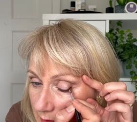 this warm autumn eye makeup for older eyes is perfect for fall, Applying dark eyeshadow at the base of lashes