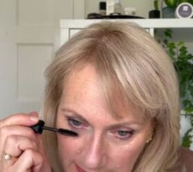 this warm autumn eye makeup for older eyes is perfect for fall, Applying mascara to bottom lashes