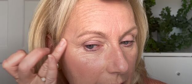 how to do a pretty soft autumn makeup look for mature women, Applying a peach colored cream blush