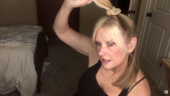 how to easily do a wolf cut with curtain bangs at home, Tying hair in a high ponytail