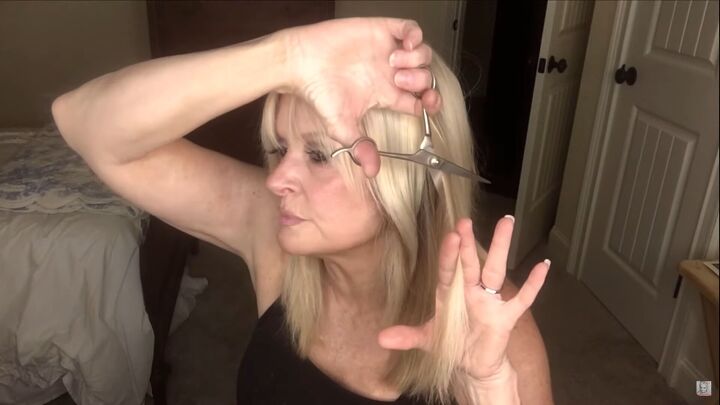 how to easily do a wolf cut with curtain bangs at home, Razor cutting the sides of hair