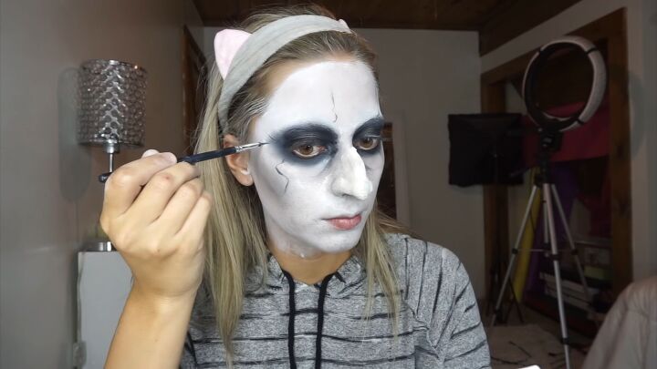 how to do super spooky makeup for a terrifying valak the nun costume, Drawing crow s feet on the face