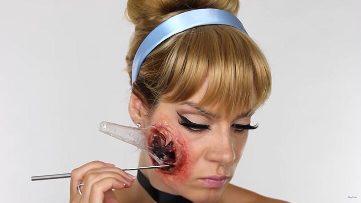 how to do scary halloween cinderella makeup with a glass slipper wound, Painting the deep wound with black FX paint